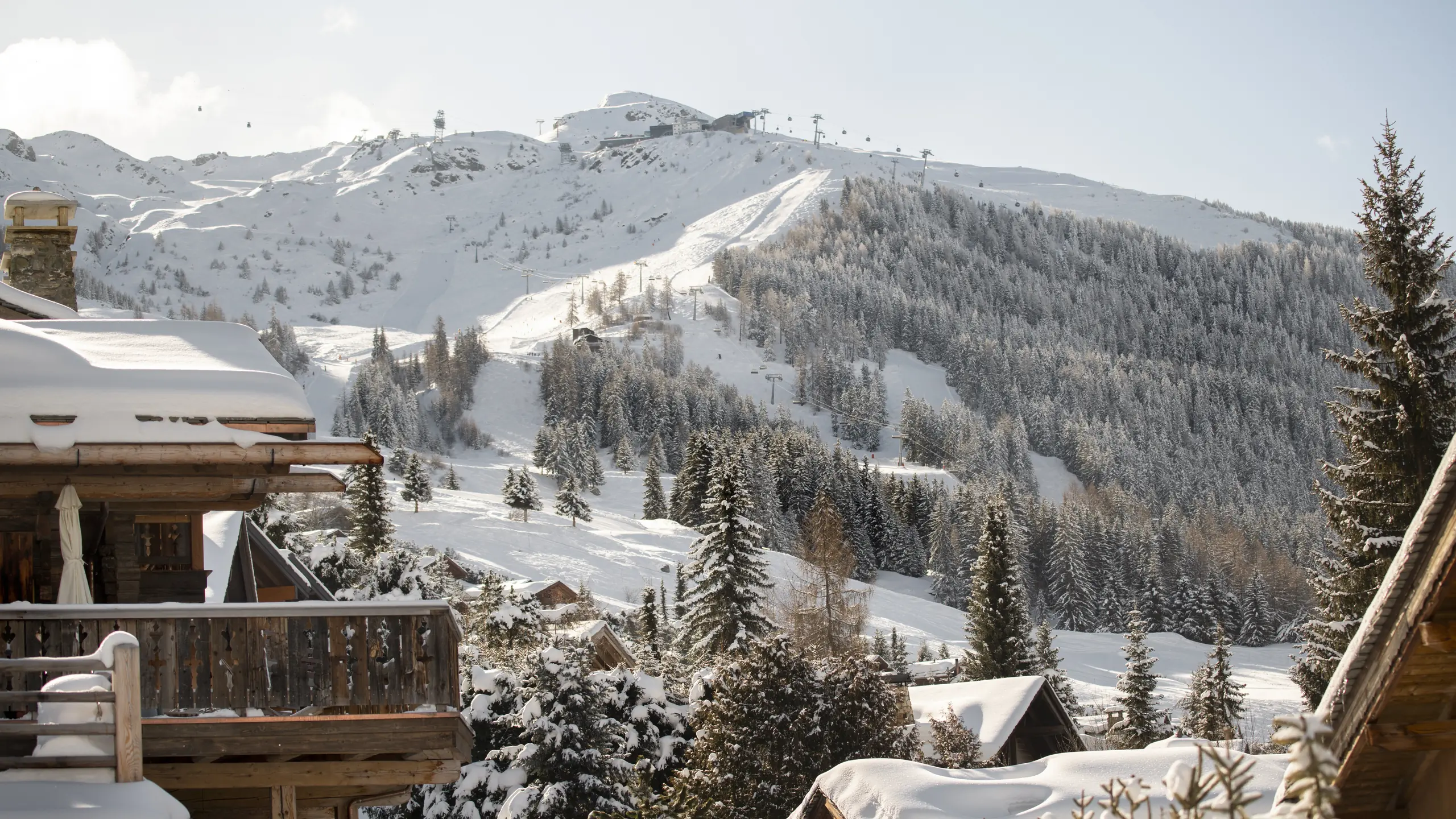 Snow-covered chalets of Verbier with the ski slopes behind