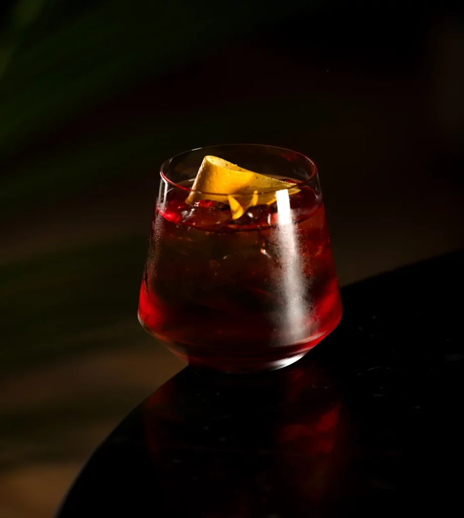 Red cocktail with an orange twist at The Listening Room