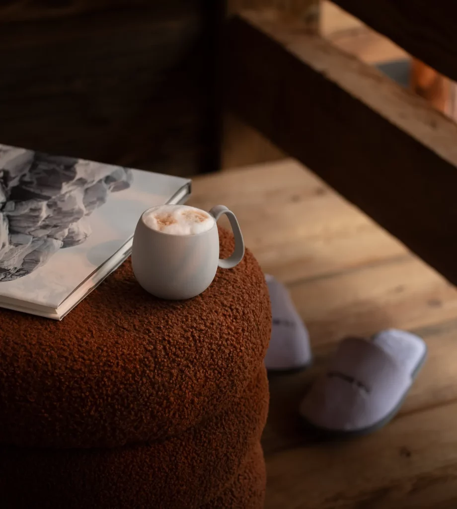 Coffee, a book and slippers in a room at The Ski Lodge